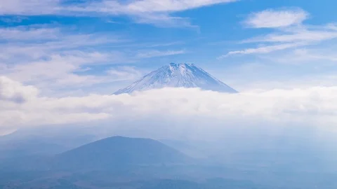 Timelapse footage of moving clouds over Mount Fuji on a sunny day, Yamanashi Stock Footage 121939644