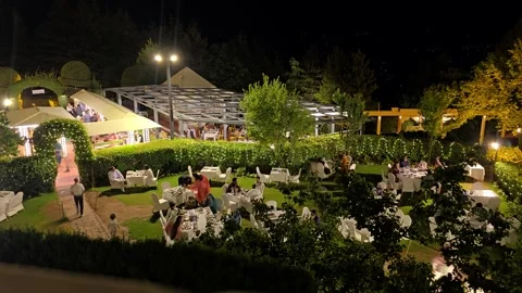 A timelapse footage of people dining in an open air restaurant. Stock Footage 340059986