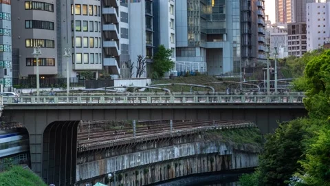 Timelapse footage of a Soba Line commuters crossing a bridge over the Kanda Stock Footage 338363482