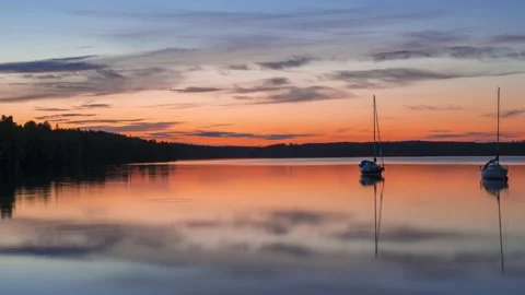 Timelapse footage of sunset lake with different boats Stock Footage 136048136