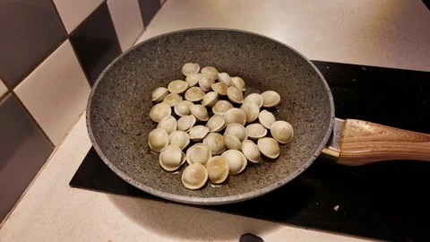 Timelapse frying dumplings with egg in pan showing home cooking process Stock Footage 319061766