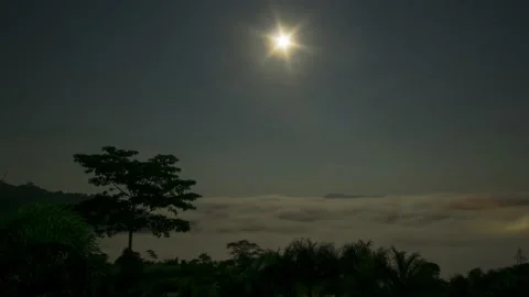 Timelapse Full moon reflecting bright light Above the sea of fog at dawn The  Stock Footage 160566504