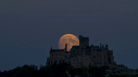 Timelapse of full moon rising over St Michael's Mount, 4K Stock Footage 220677783