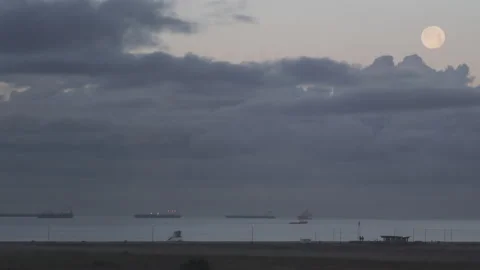 Timelapse Full Moon Sets over Active Ocean Scene Stock Footage 205960152