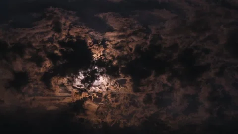Timelapse of full moon shining through dramatic night clouds with starry sky Stock Footage 341756720