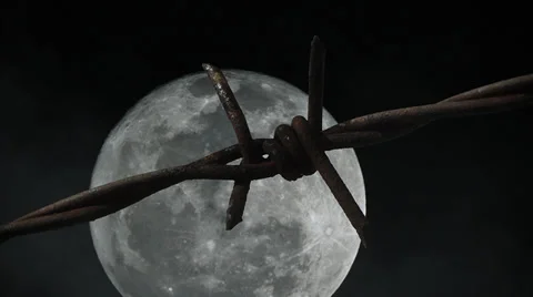 Timelapse of full moon, starry sky and barbed wire in prison Video stock 39195543