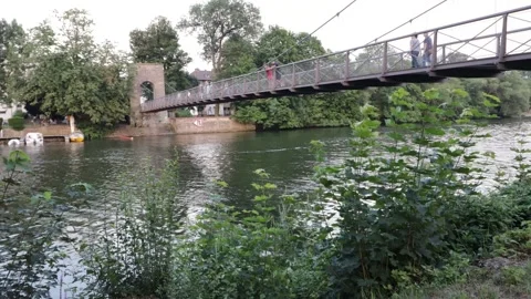 Timelapse of the German River "Fulda" in a German Town with a Suspension Bridge Stock Footage 137278718
