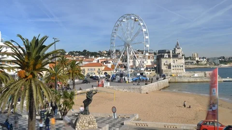 Timelapse of giant ferris wheel entertaining locals and tourists at Cascais Stock Footage 100183068