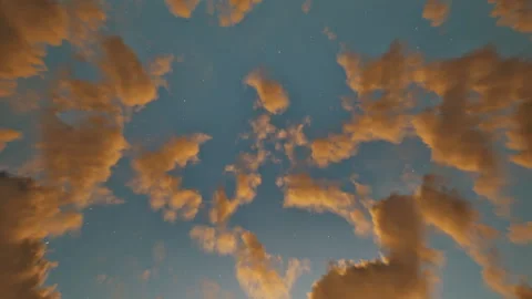 Timelapse of golden clouds on the starry sky in the morning or evening Video stock 242569346