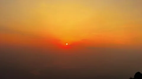 Timelapse of Golden Sun Setting Over a Vast Cloud Sea in Mountainous China Stock Footage 337859285