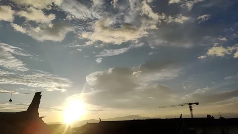 Timelapse of Golden Sunset with Moving Clouds Over Yunnan Rooftops and Mountains 스톡 동영상 336060836