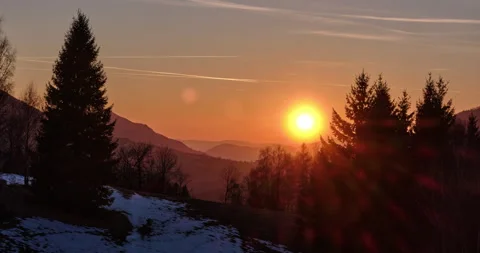 Timelapse of golden sunset over winter mountain landscape with silhouettes of Stock Footage 331199586