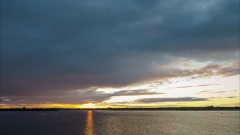Timelapse of golden sunset with rainy clouds. Stock Footage 133902090