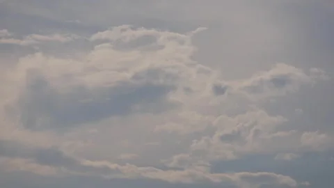 Timelapse of gray and white clouds drifting slowly across an open sky. Weather p Stock Footage 339280026