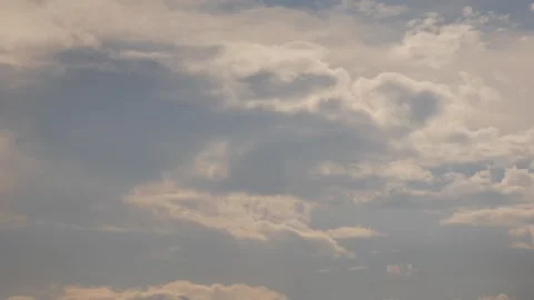 Timelapse of gray and white clouds drifting slowly across an open sky. Atmospher Видео 341408900