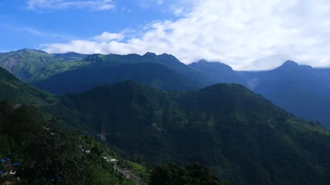 Timelapse of green hills and clouds revealing bit of mountain Stock Footage 246731864