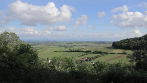 Timelapse of a green landscape with clouds passing by Stock Footage 208844157