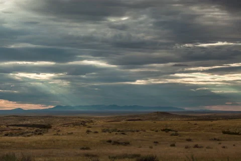 Timelapse grey evening clouds racing towards camera from mountain range Stock Footage 62189343