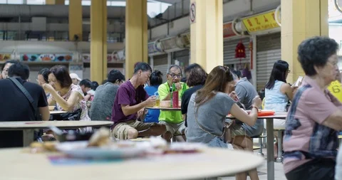 Timelapse of group of middle-aged Asian people sitting at a hawker centre Video stock 127154684