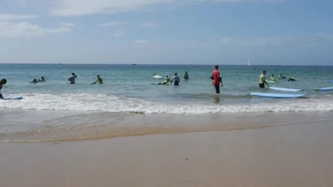Timelapse of a group of young surfers at Carcavelos beach near Lisbon, Portugal Stock Footage 250472162