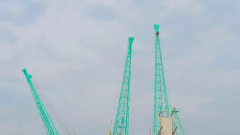 Timelapse: harbor cranes during work against cloudy sky in the sea port Stock Footage 340429401
