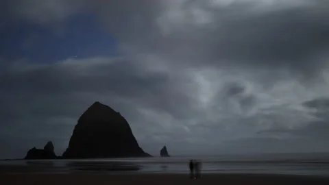 Timelapse of Haystack Rock surroundings in Cannon Beach washed with low tides Stock Footage 229915570