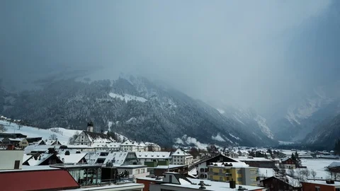 Timelapse of heavy blizzard clouds covering Swiss mountains close to Engelberg Stock Footage 129099639