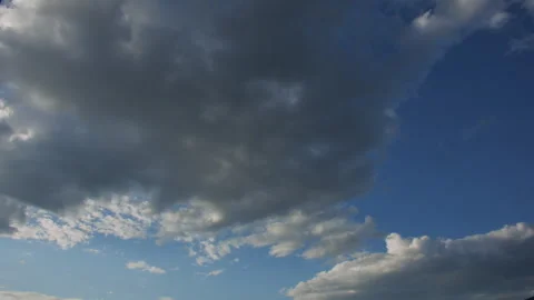 Timelapse - heavy clouds cross sky into sunset and black, 4k Stock Footage 253814595