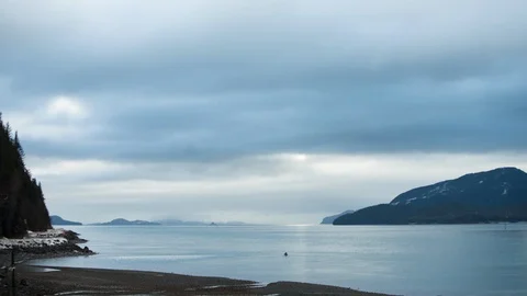 Timelapse of heavy clouds passing on sky with heavy fog setting on water surface Stock Footage 129114399