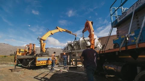Timelapse of heavy fruit press being installed at apple orchard Stock Footage 328975972
