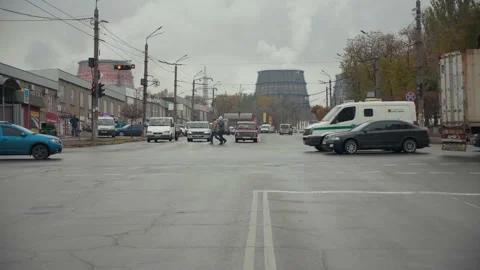 Timelapse heavy traffic at the intersection on against the cooling towers of the Stock Footage 198640454