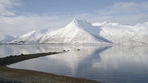 Timelapse of high altitude mountains and lake reflecting cloudy sky Stock Footage 121574238
