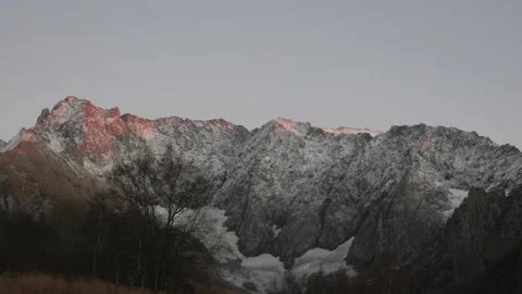 Timelapse of high snow-capped mountains of the north Caucasus after sunset. Video stock 142871984