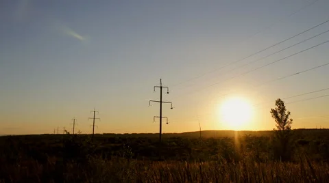 Timelapse high voltage electricity power lines at sunset above the beautiful 스톡 동영상 66573166