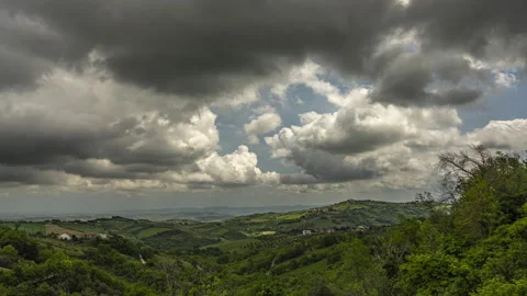 Timelapse of a hilly landscape with clouds that run fast Stock Footage 154372381