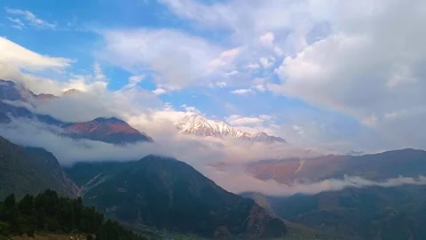 Timelapse of Himalayan mountain and drifting clouds with colourful rainbow .. Video stock 279872296