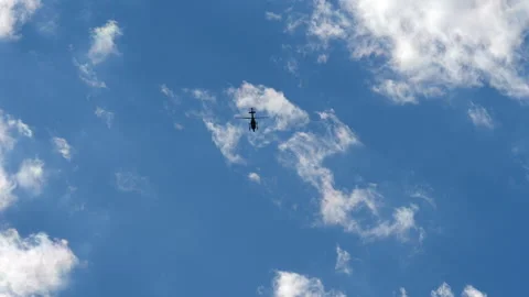 Timelapse of a Hovering Helicopter With White Clouds Stock Footage 131679295