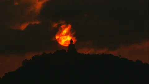Timelapse hue sunset over and behind silhouette Phuket big buddha statue on h Stock Footage 127806891