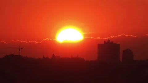 Timelapse of Huge Full Red Sun going to Sunset above the City Stock-Footage 80147369
