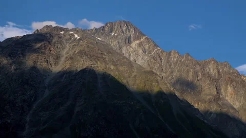 Timelapse of huge shadow move over mountains surface, rocky summit in Kazbegi Stock Footage 254763173