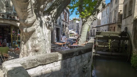 Timelapse hyperlapse of medieval water mill in Avignon street, people at cafe Stock Footage 100876632