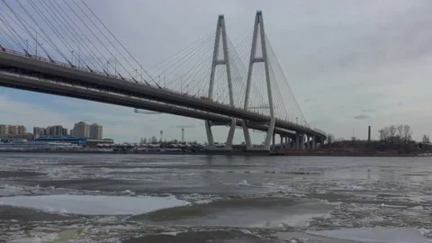 Timelapse of ice movement along the river under a cable-stayed bridge Stock Footage 172541188