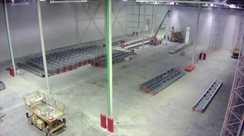 Timelapse installation of racks in large warehouse facility Stock Footage 65981889