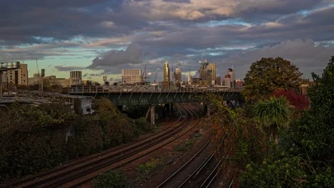 Timelapse of Inter city trains in front of London skyscrapers at sunset Stock Footage 143297654