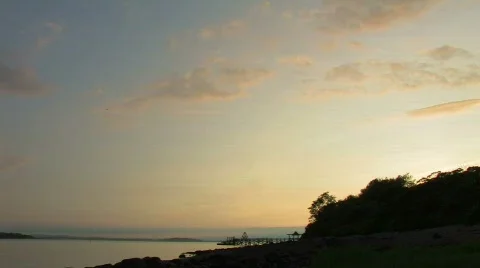 Timelapse - Island dusk moving clouds w pier Stock Footage 558347