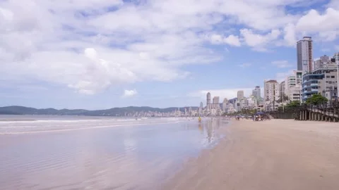 Timelapse of Itapema beach with people walking and buildings in the background Stock Footage 329010102