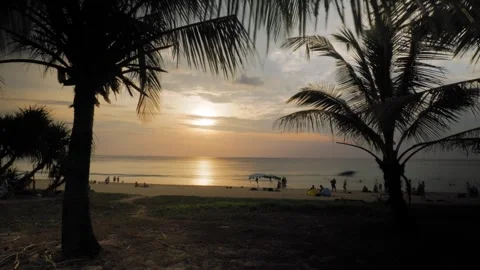 Timelapse Karon beach sunset, palm trees, waves, water scooters, red sun Stock Footage 246060562