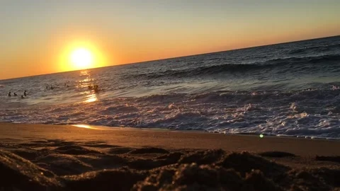 Timelapse of kids playing in the beach under the sunset Stock Footage 130408561