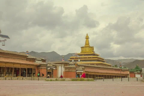 Timelapse Labrang Monastery stupa with prayer wheels and a monk Stock Footage 56236887