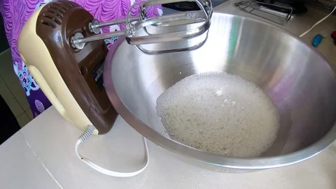Timelapse of A lady Hands Mixing White Egg Cream In Bowl Using Motor Mixer Stock Footage 109407102